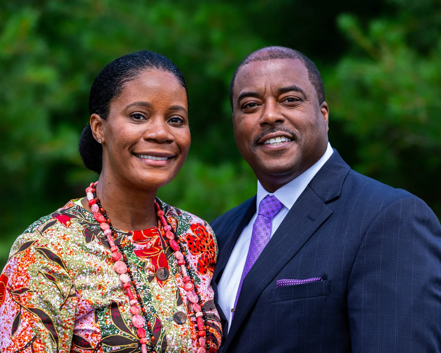 Two smiling people in a natural outdoor portrait