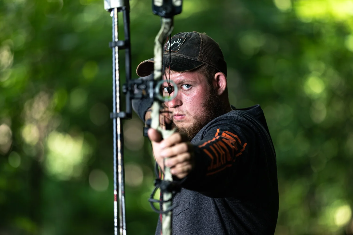 Outdoor portrait of an archer drawing a bow