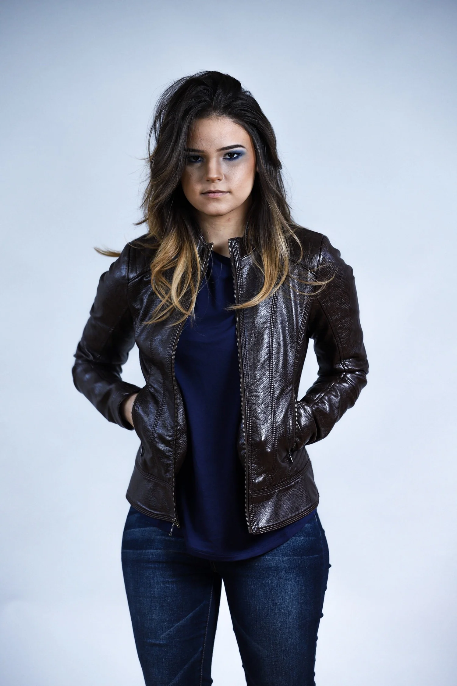 Woman in a leather jacket and blue shirt